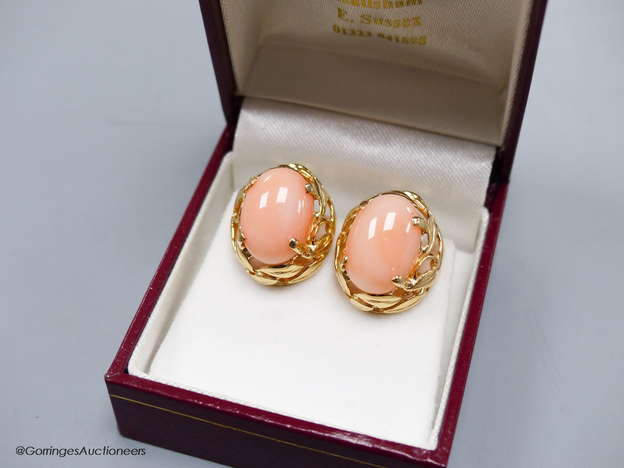 A modern pair of yellow metal (stamped 14k) and oval coral bead earrings, 16mm